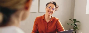 woman-with-short-hair-and-glasses-looking-at-person